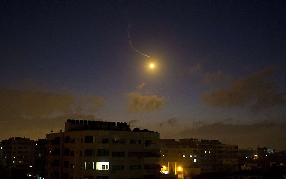 Een door de Israëlische luchtmacht afgevuurde lichtkogel verlicht de nacht boven Gaza. Beeld AFP