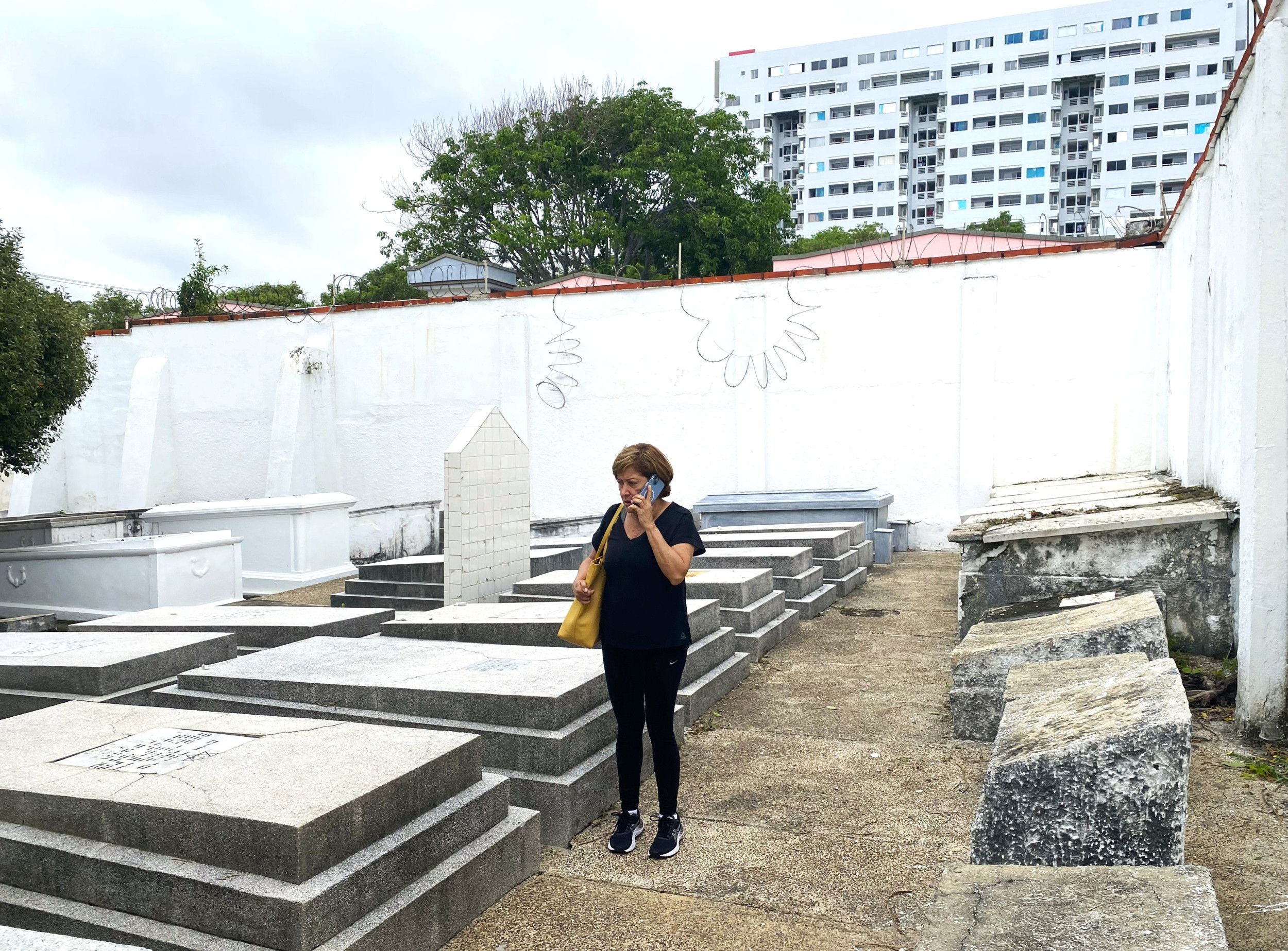 Vrouw in zwarte vrijetijdskleding, ze telefoneert.