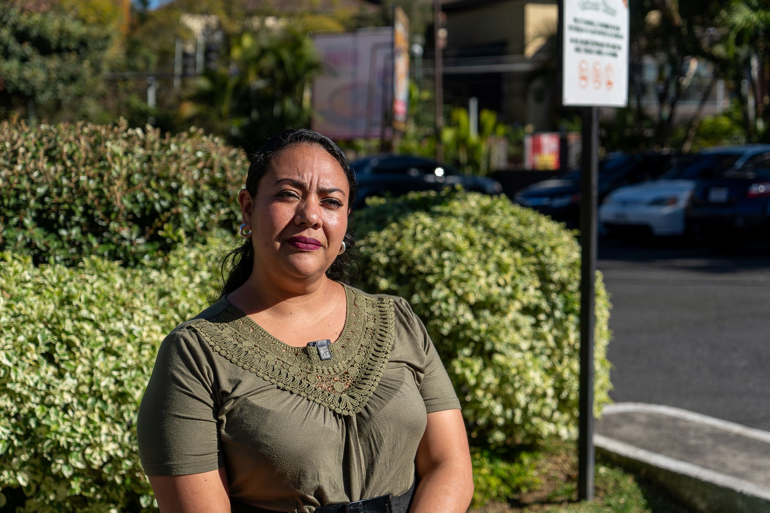 Een vrouw, bij een soort bushalte.